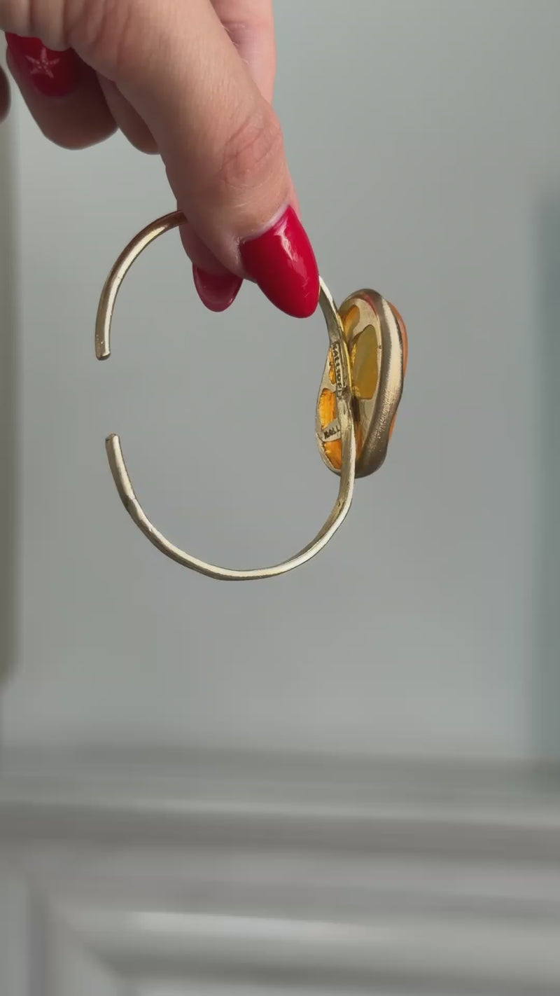 Earthpulse Bracelet detail — handmade brass adjustable cuff with polished stone accent