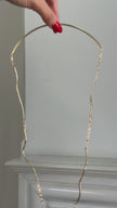 Elemental Pebble Necklace detail — handmade brass wavy link chain with trailing bar tipped chains